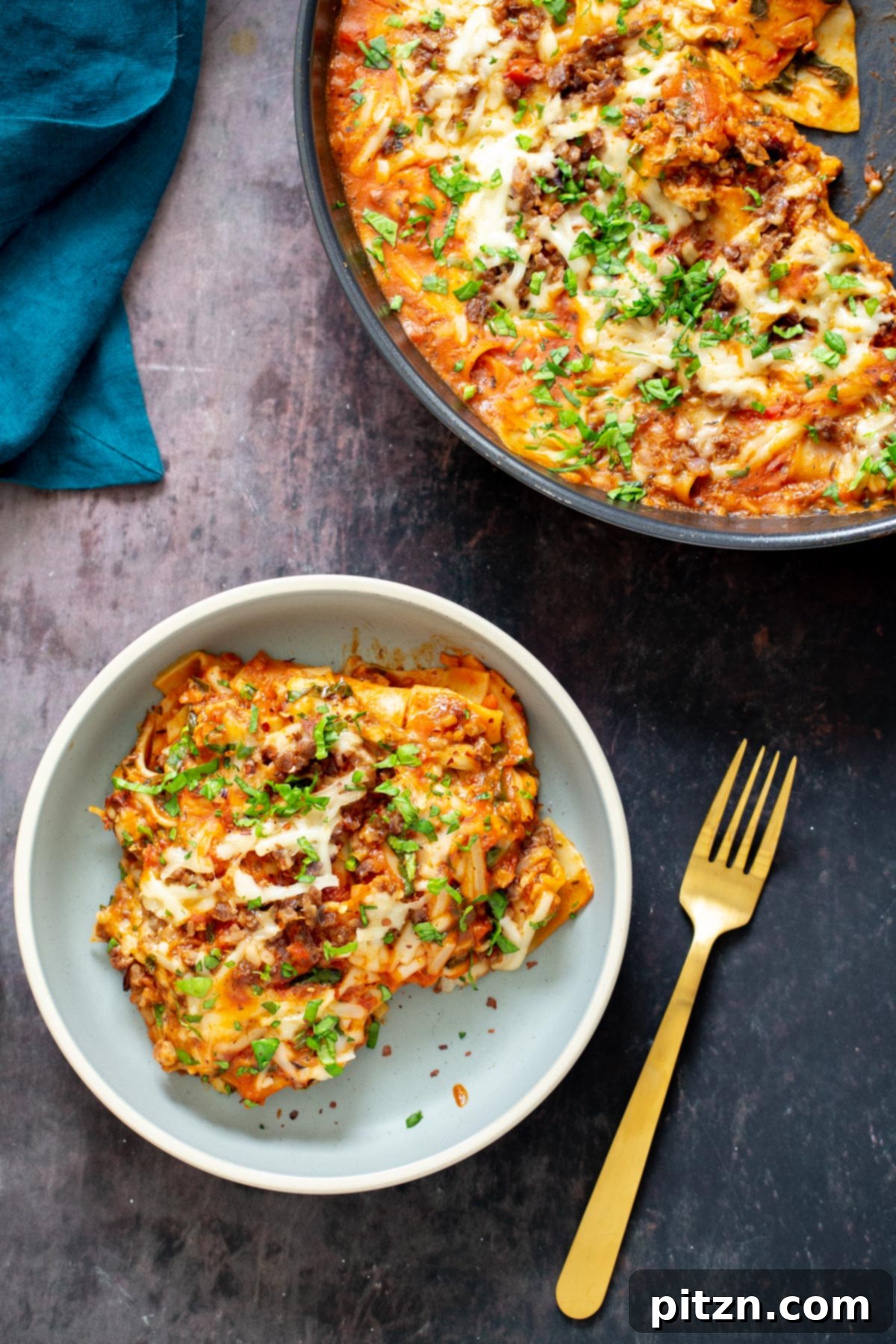 Hearty Vegan Skillet Lasagna 4 A close-up of a plate featuring a generous portion of one-skillet vegan lasagna bolognese, highlighting the rich tomato sauce and savory vegan crumbles.
