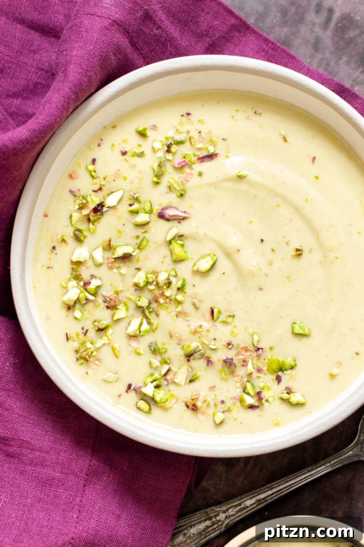 A bowl of Indian Rabri Pudding topped with chopped pistachios