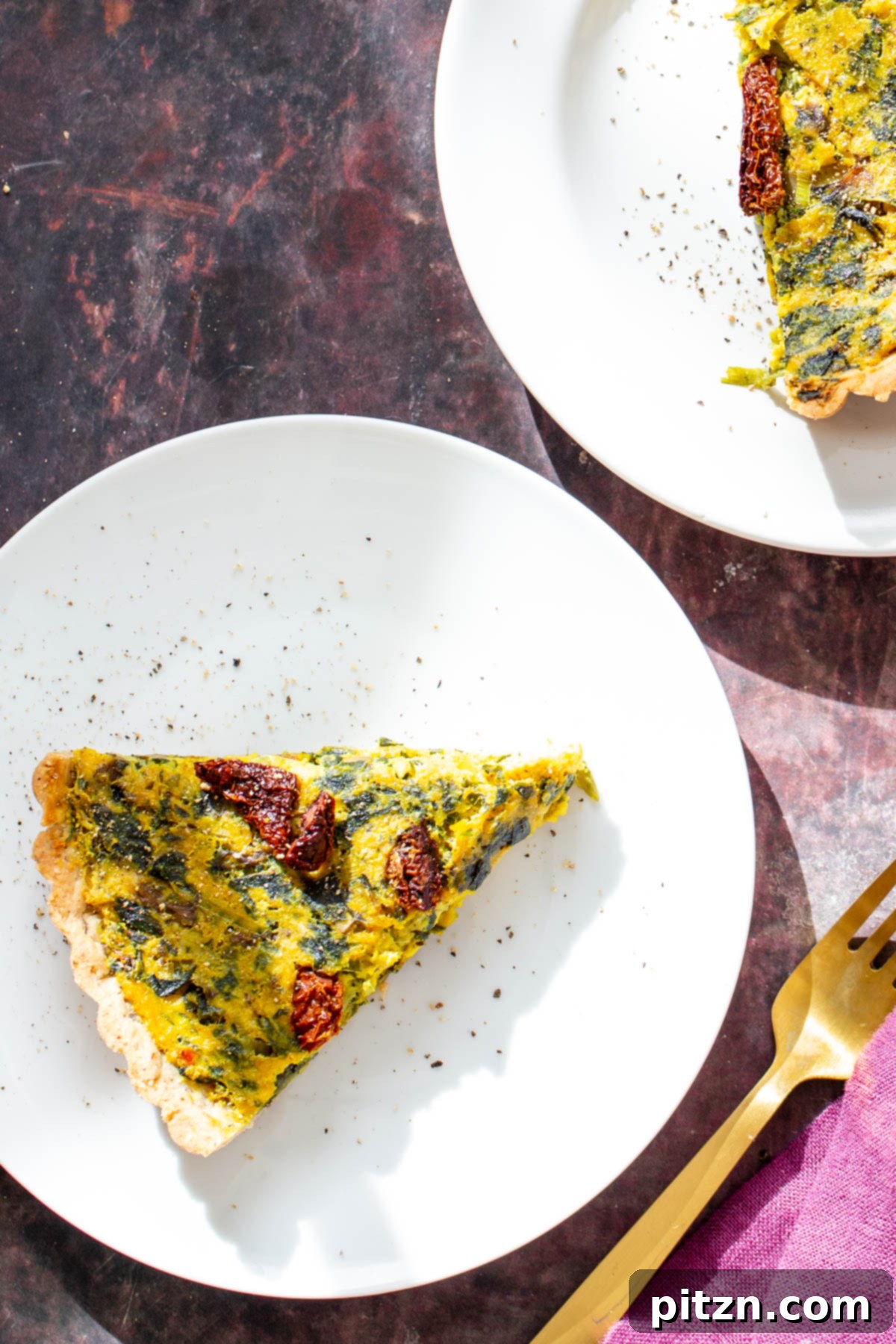 Leftover Vegan Quiche Slice Overhead shot of a delicious slice of vegan quiche, featuring its golden crust and richly colored vegetable and tofu filling, ready for enjoyment.