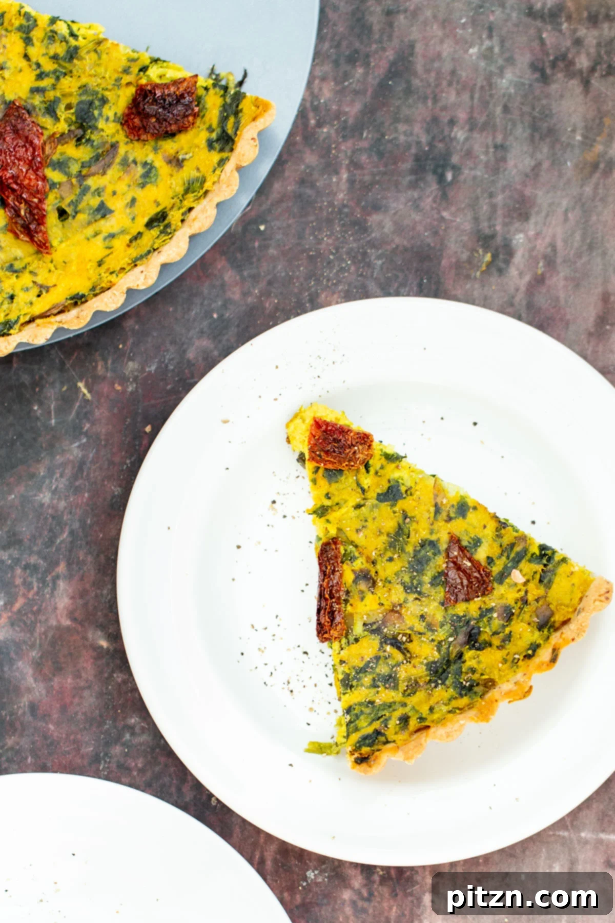 Savory Vegan Quiche with Tofu Filling Close-up shot of a single slice of homemade vegan quiche, showcasing the creamy tofu filling and vibrant vegetables. A delicious plant-based brunch option.