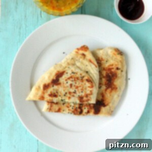 Slices of vegan naan bread on a white plate