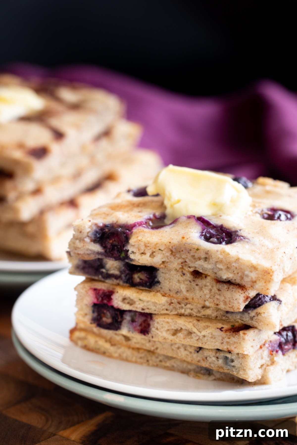vegan sheet pan pancakes stacked vegan sheet pan pancakes topped with a dollop of vegan butter