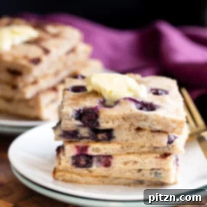 vegan sheet pan pancakes stacked on a white plate