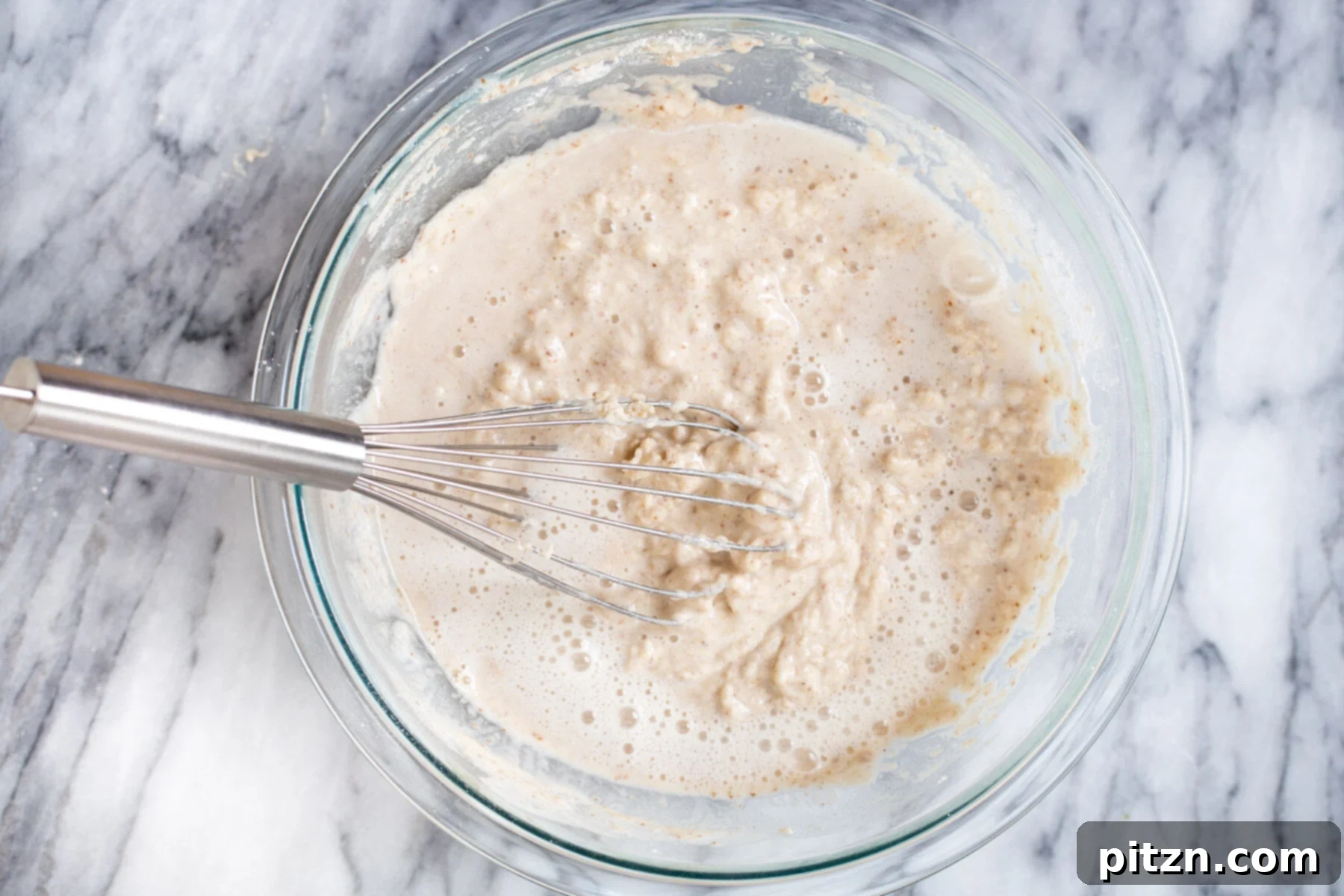 vegan sheet pan pancakes club soda being added to pancake batter to make sheet pan pancakes