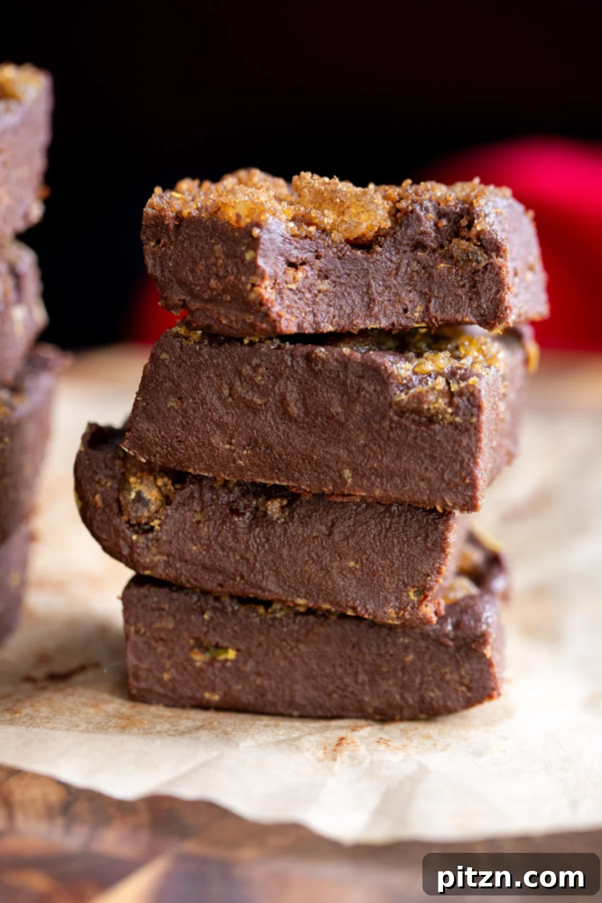 a stack of vegan gingerbread fudge topped with candied ginger and brown sugar