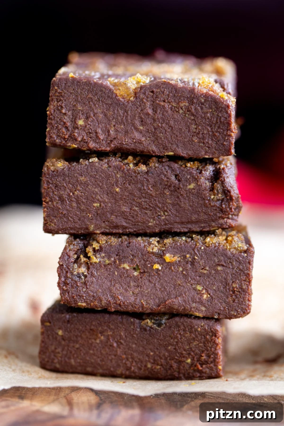 a stack of vegan gingerbread fudge topped with crystalized ginger and brown sugar