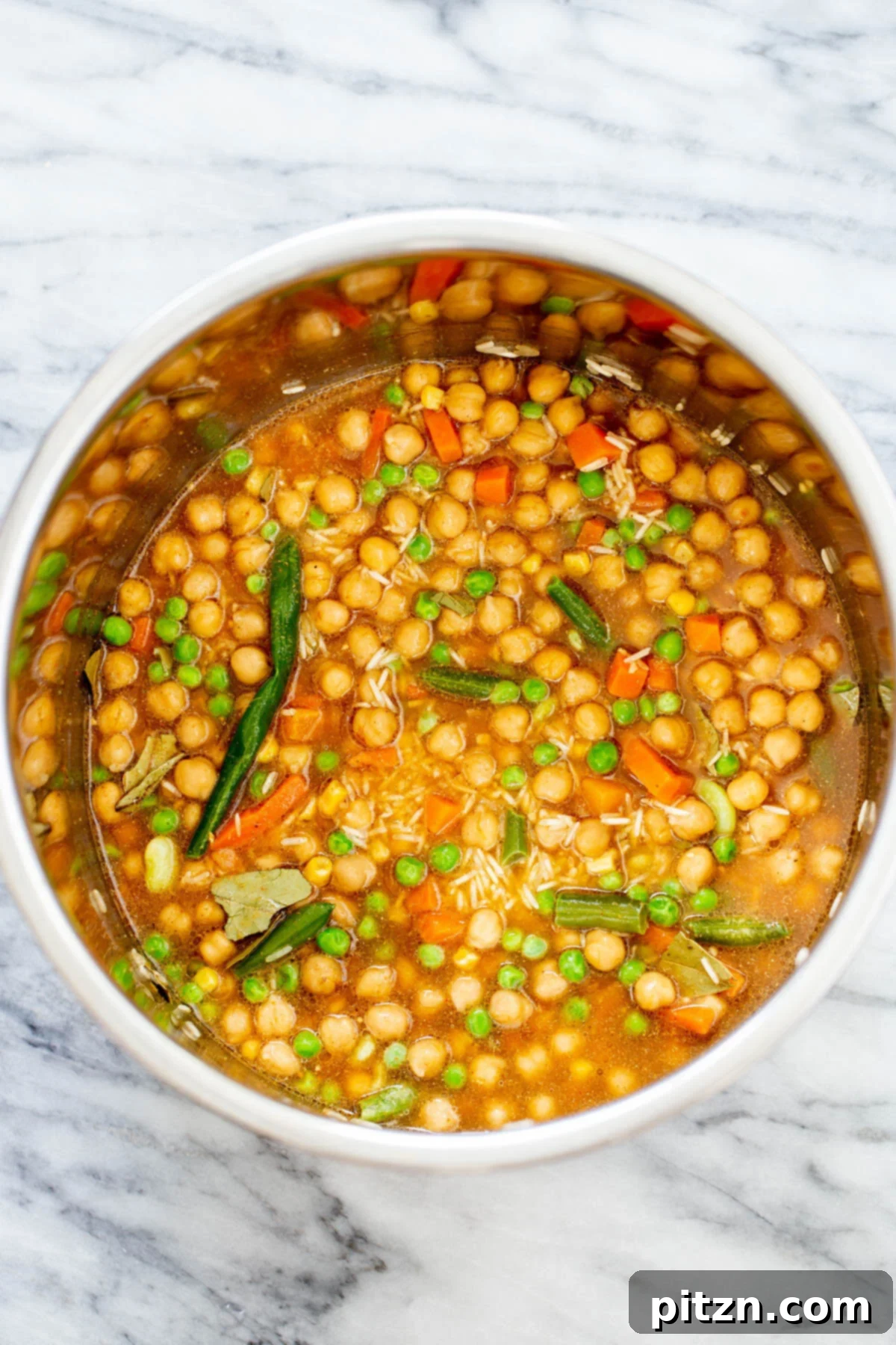 chickpea fried rice broth being added to dry ingredients to make chickpea fried rice