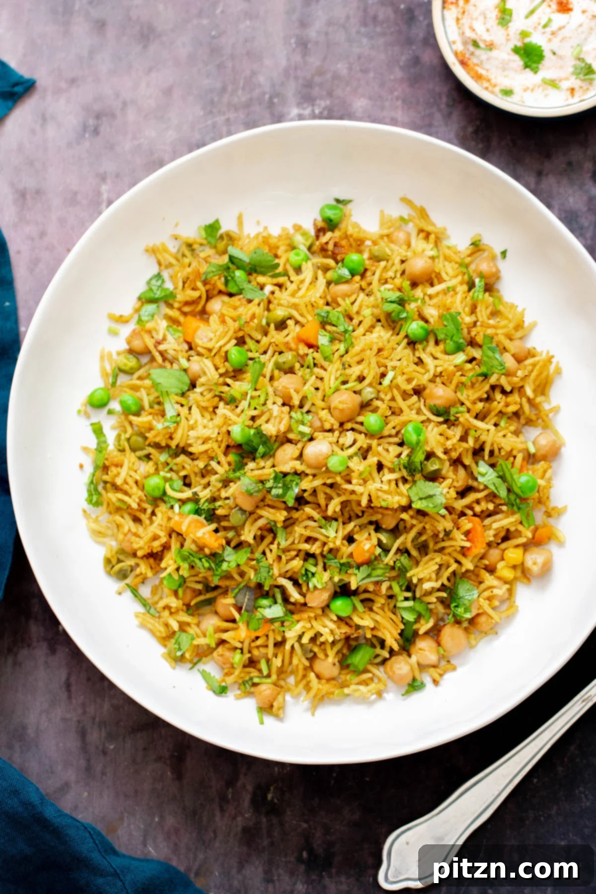 chickpea fried rice chickpea fried rice with peas and cilantro on a white plate