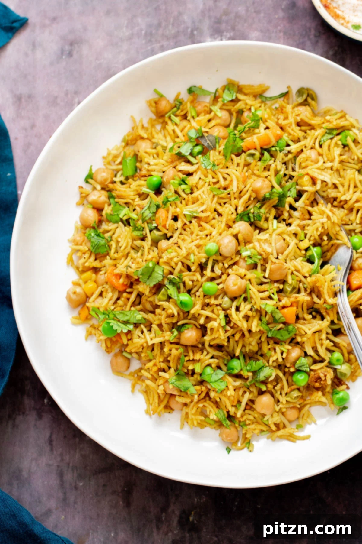 chickpea fried rice chickpea fried rice on a white plate with a fork