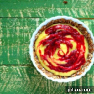 Award Winning No Bake Mango Beet Pie with Wholesome Crunchy Crust Vegan Gluten-Free Oil-Free 2 Top down shot of a beet cream pie on a green back ground