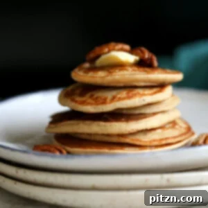 Banana Oat Pancakes Stacked on white plates