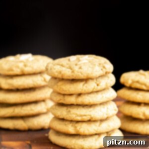 vegan pistachio cookies stacked on a wooden board