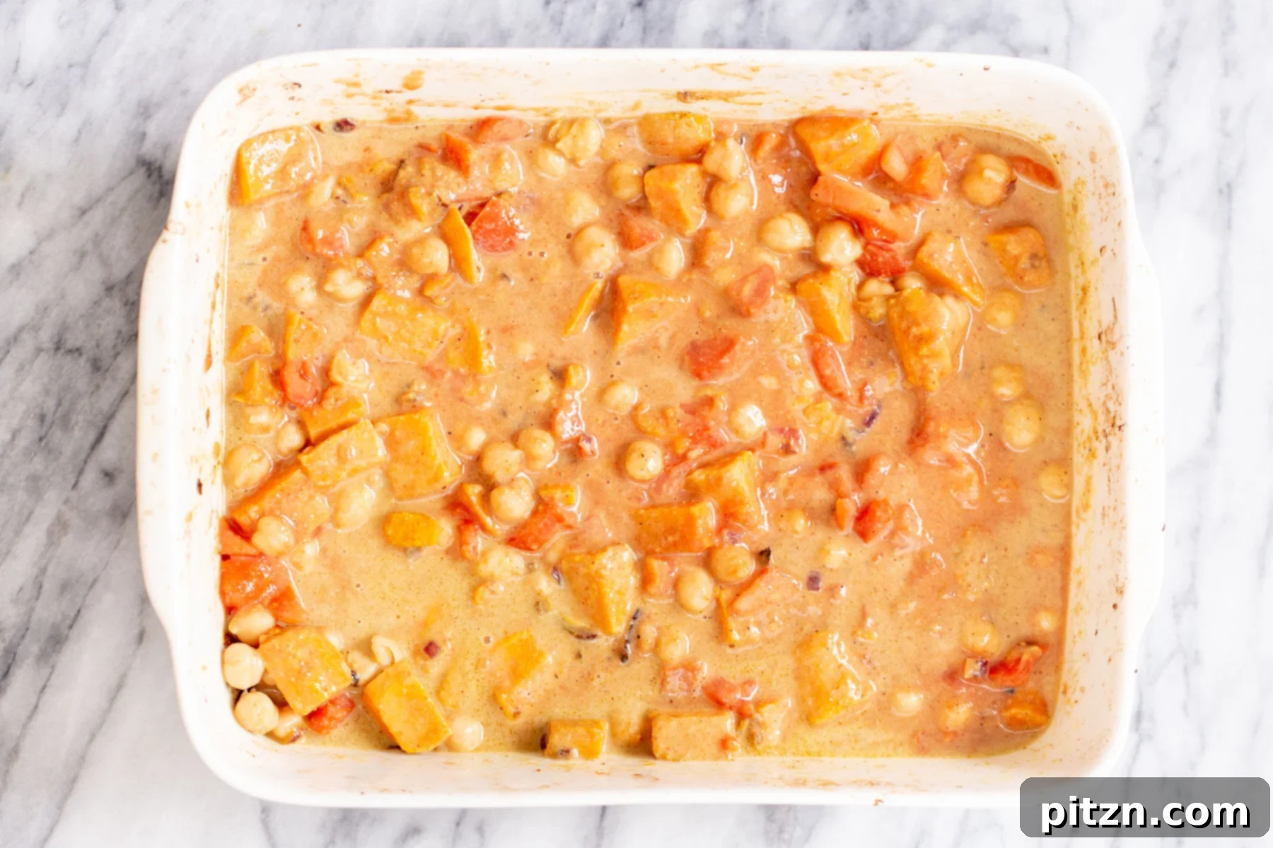 Sweet Potato and Chickpea Curry Bake 12 A casserole dish filled with bubbling, richly textured chickpea sweet potato curry in a creamy gravy, fresh and hot from the oven
