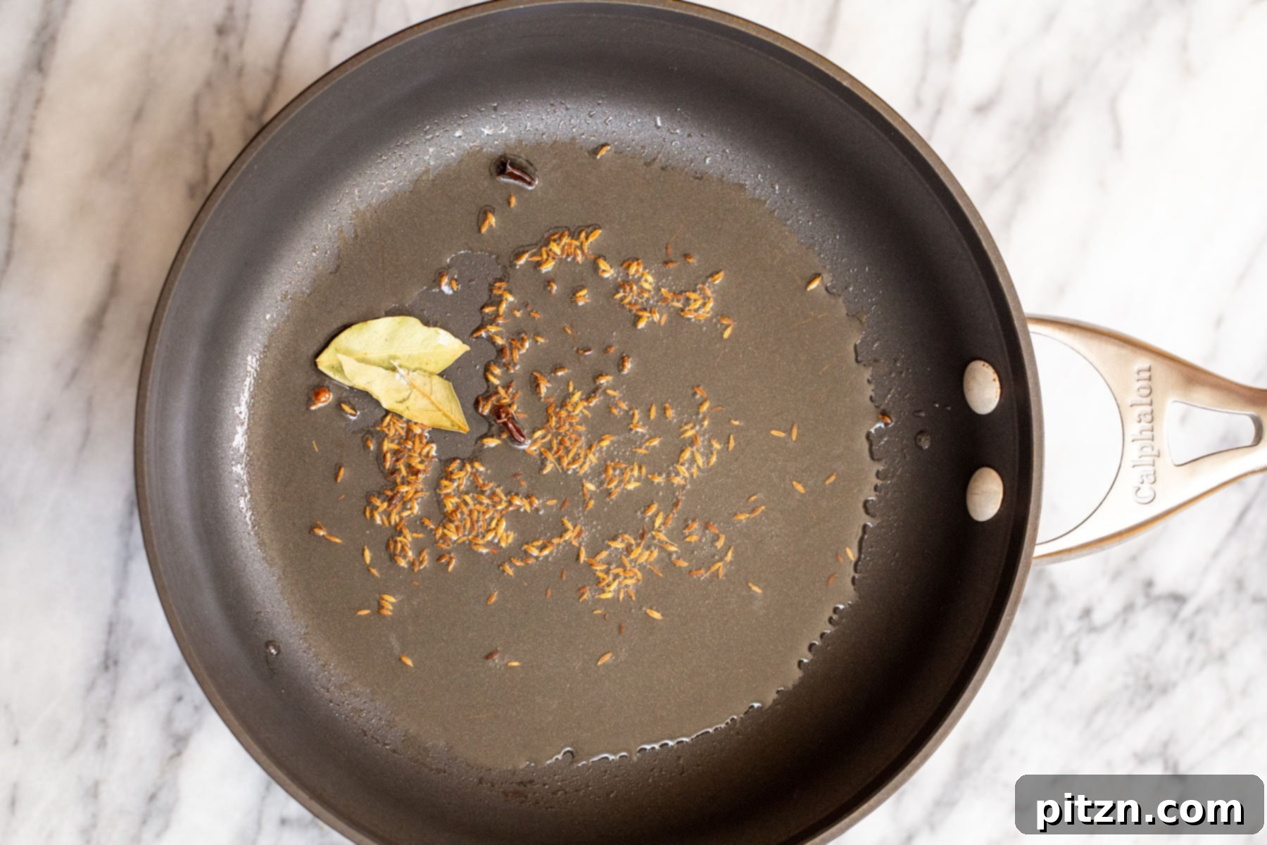 Spicy Black Gram Dal 7 Cumin seeds, bay leaves, and cloves sizzling in hot oil during the tempering process