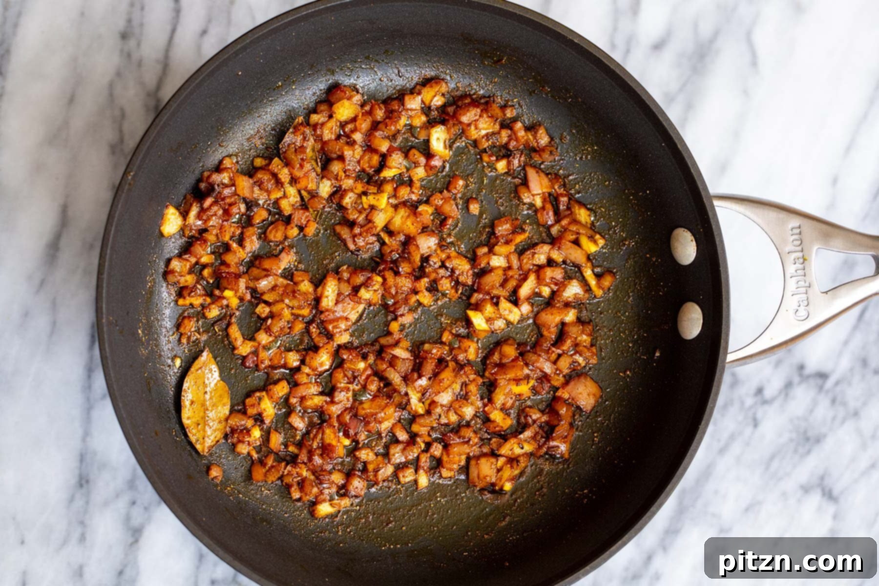 Spicy Black Gram Dal 11 Sautéed onions with Indian spices in a black skillet, perfectly browned and fragrant