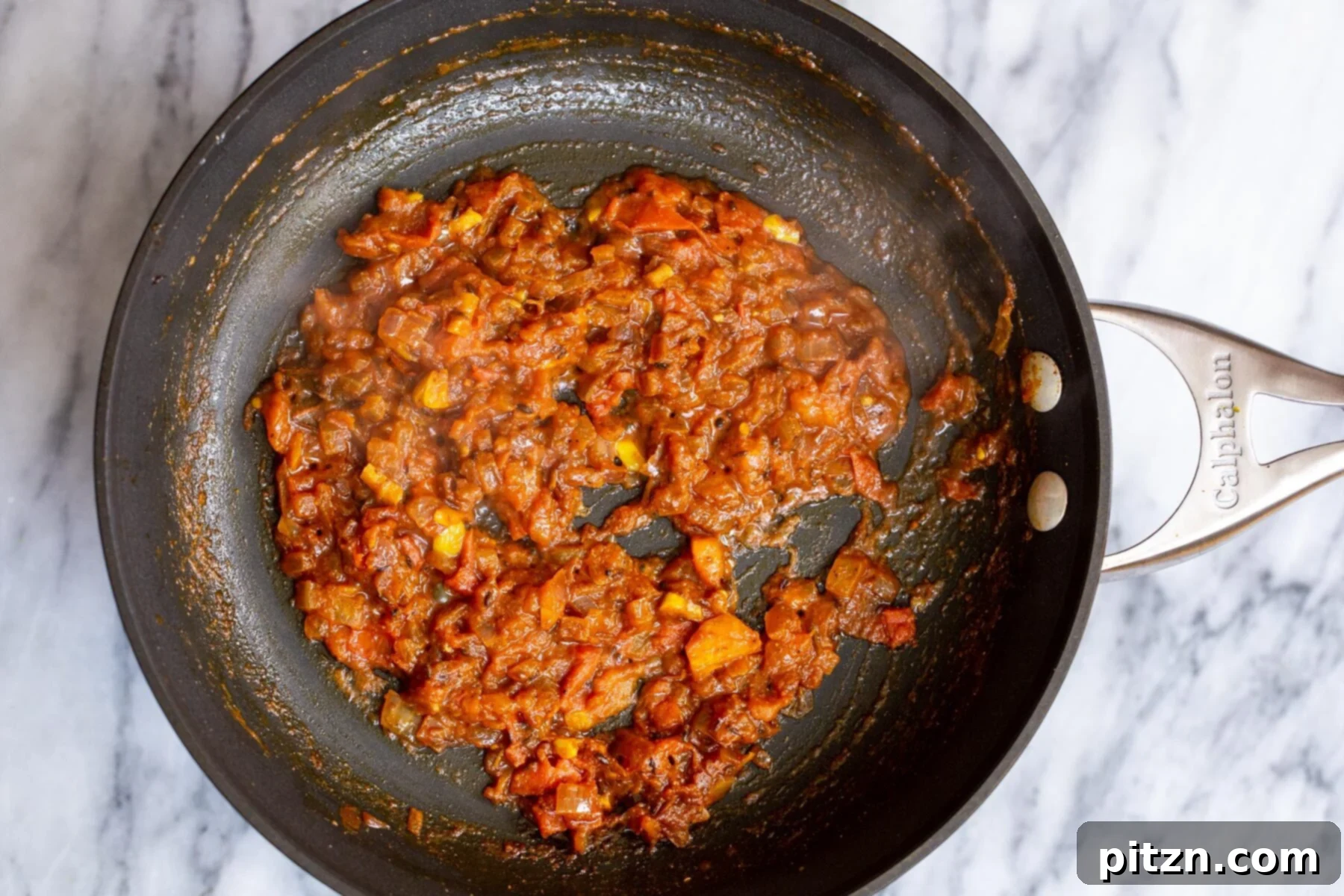 Spicy Black Gram Dal 14 The rich and aromatic base for urad dal simmering in a skillet