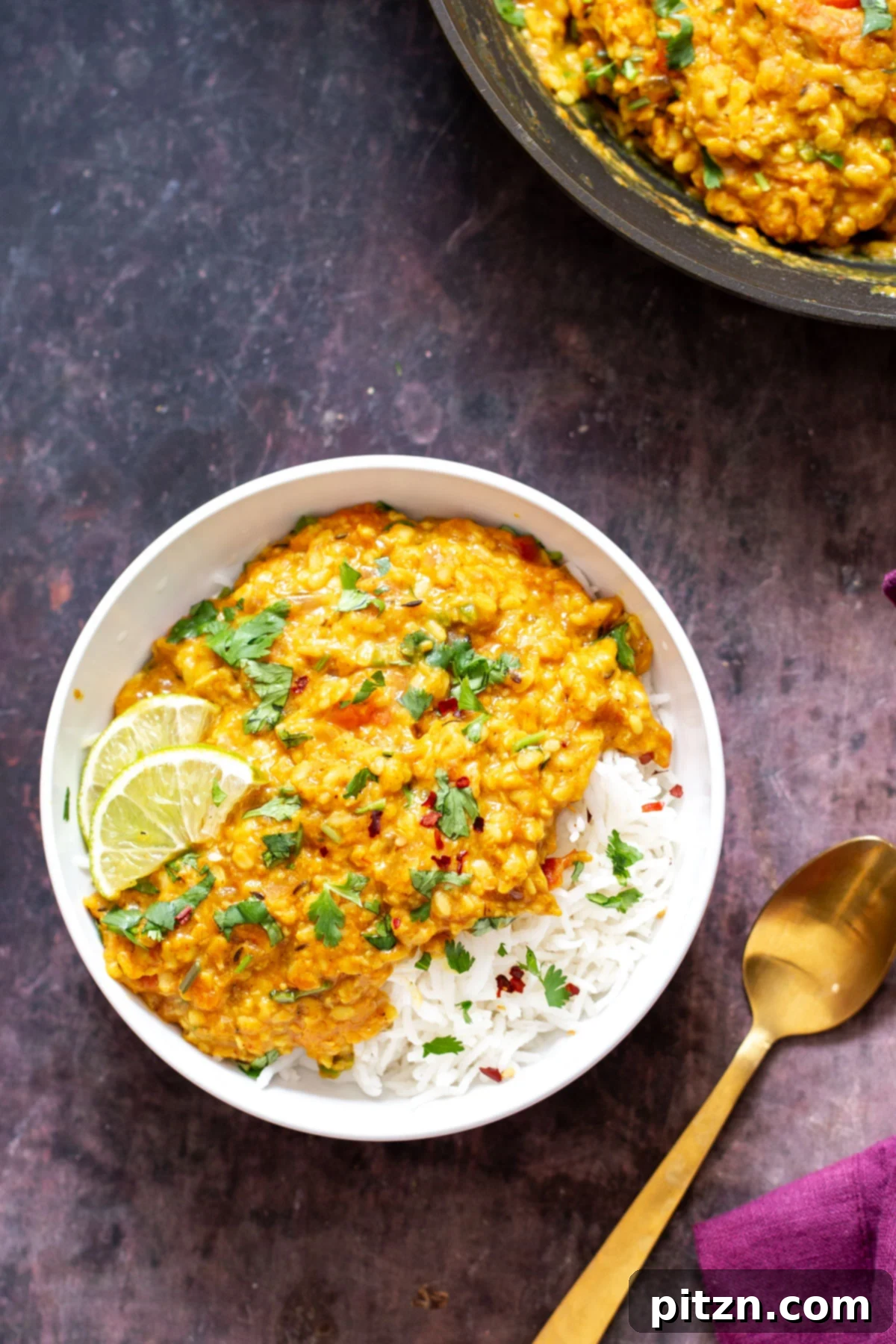 spicy urad daal Spicy urad daal served alongside rice, garnished with fresh herbs, ready for a comforting meal