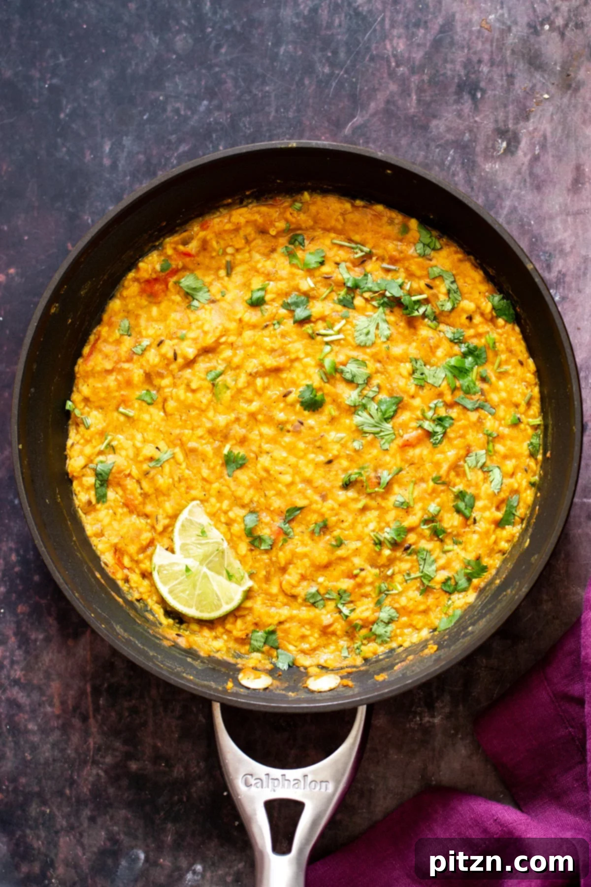 Spicy Black Gram Dal 2 Spicy Urad Dal simmering in a black skillet, rich with aromatic spices and a creamy texture