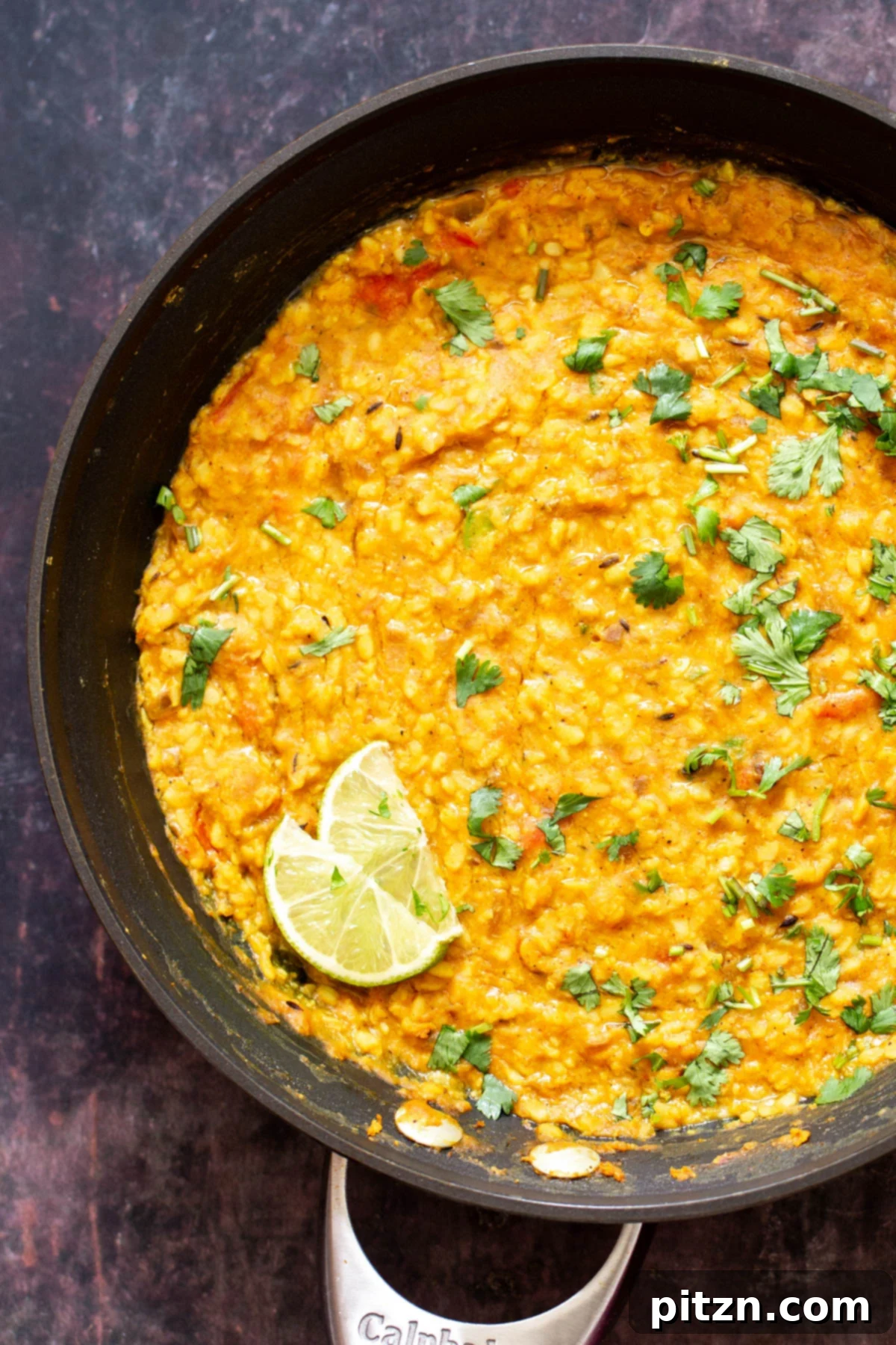 Spicy Black Gram Dal 4 Close-up of Spicy Urad Dal in a deep serving bowl, showcasing its rich texture and garnishes