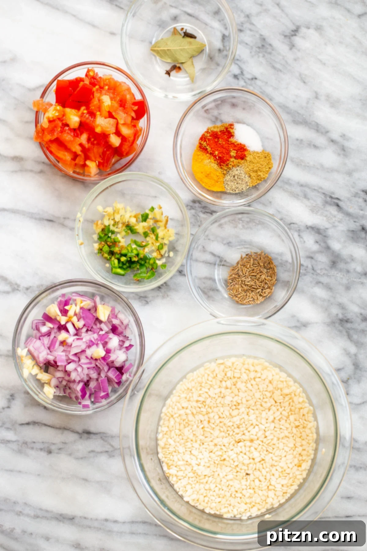 Spicy Black Gram Dal 5 Ingredients for Spicy Urad Dal laid out on a wooden surface, including lentils, spices, onions, garlic, and tomatoes