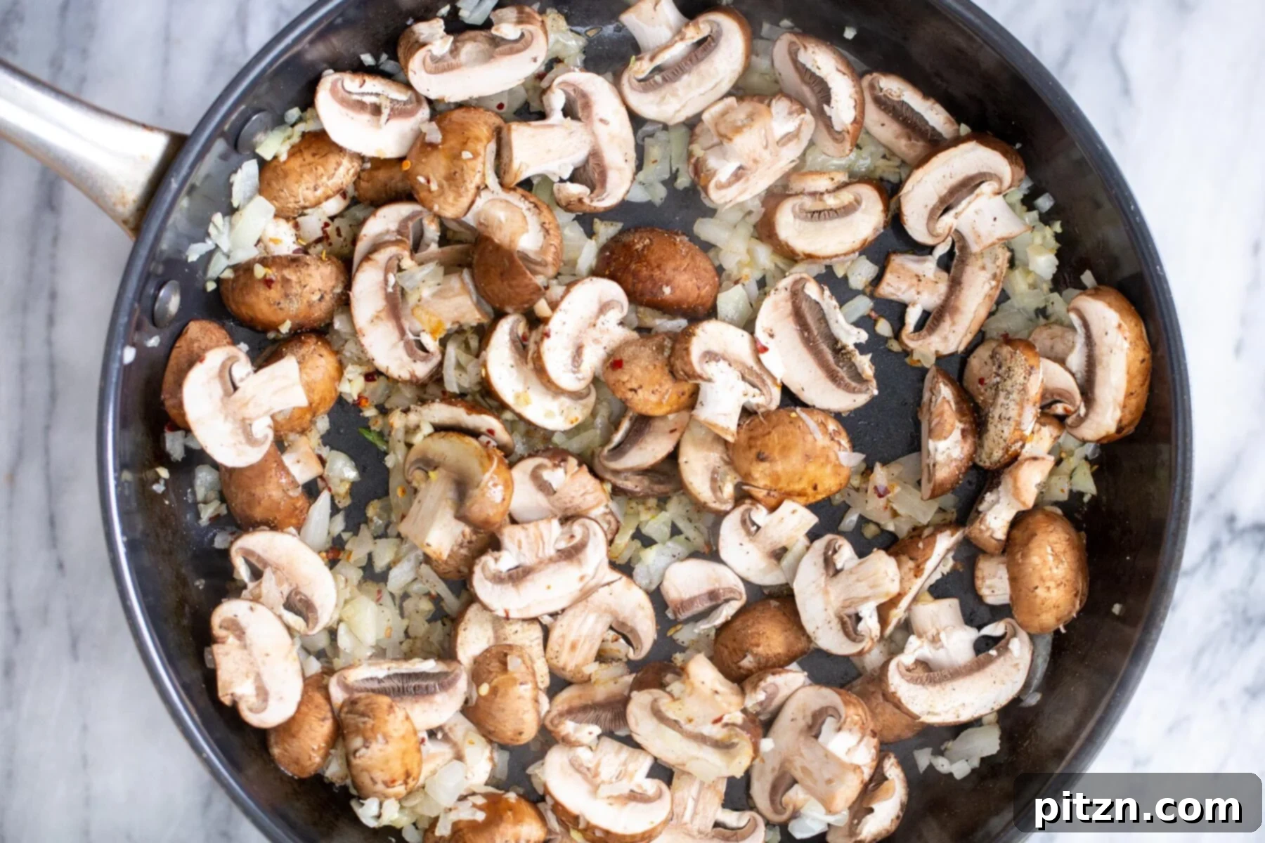 Effortless One-Pan Vegan White Lasagna with Tofu Bechamel 10 sliced baby bella mushrooms cooked in a sauteeing pan