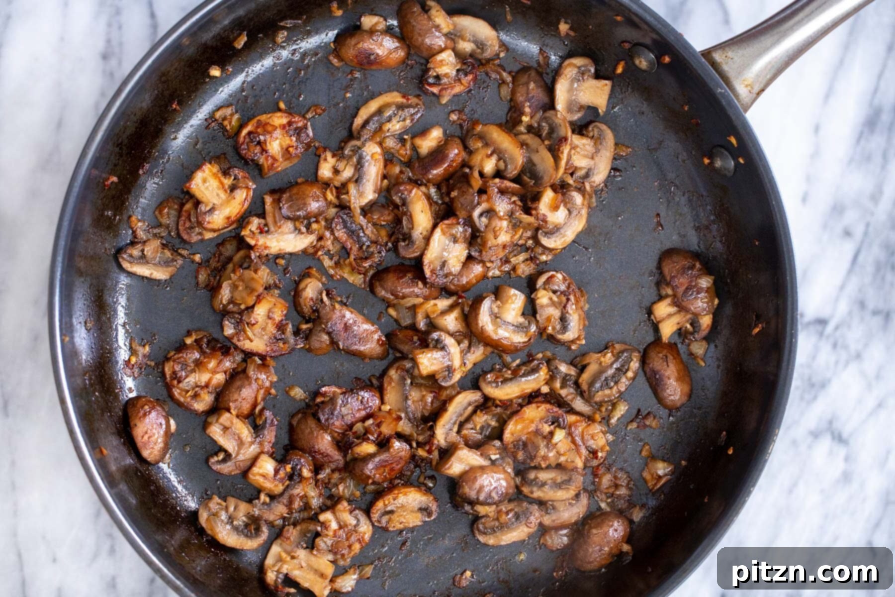 Effortless One-Pan Vegan White Lasagna with Tofu Bechamel 11 sauteed balsamic mushrooms in a black skillet