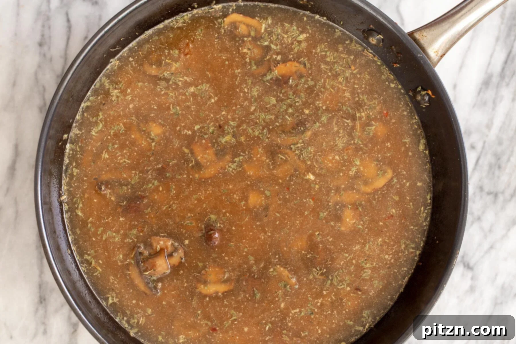 Effortless One-Pan Vegan White Lasagna with Tofu Bechamel 13 mushroom broth in a skillet