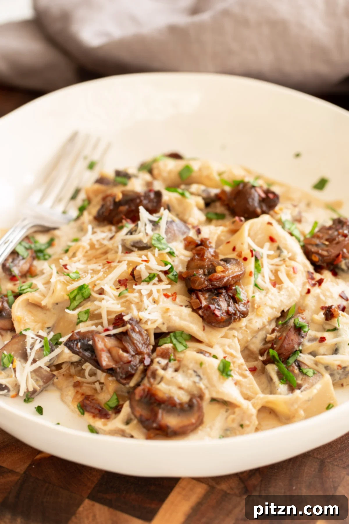 Effortless One-Pan Vegan White Lasagna with Tofu Bechamel 4 side view of a plate of vegan skillet lasagna with balsamic mushrooms and vegan bechamel