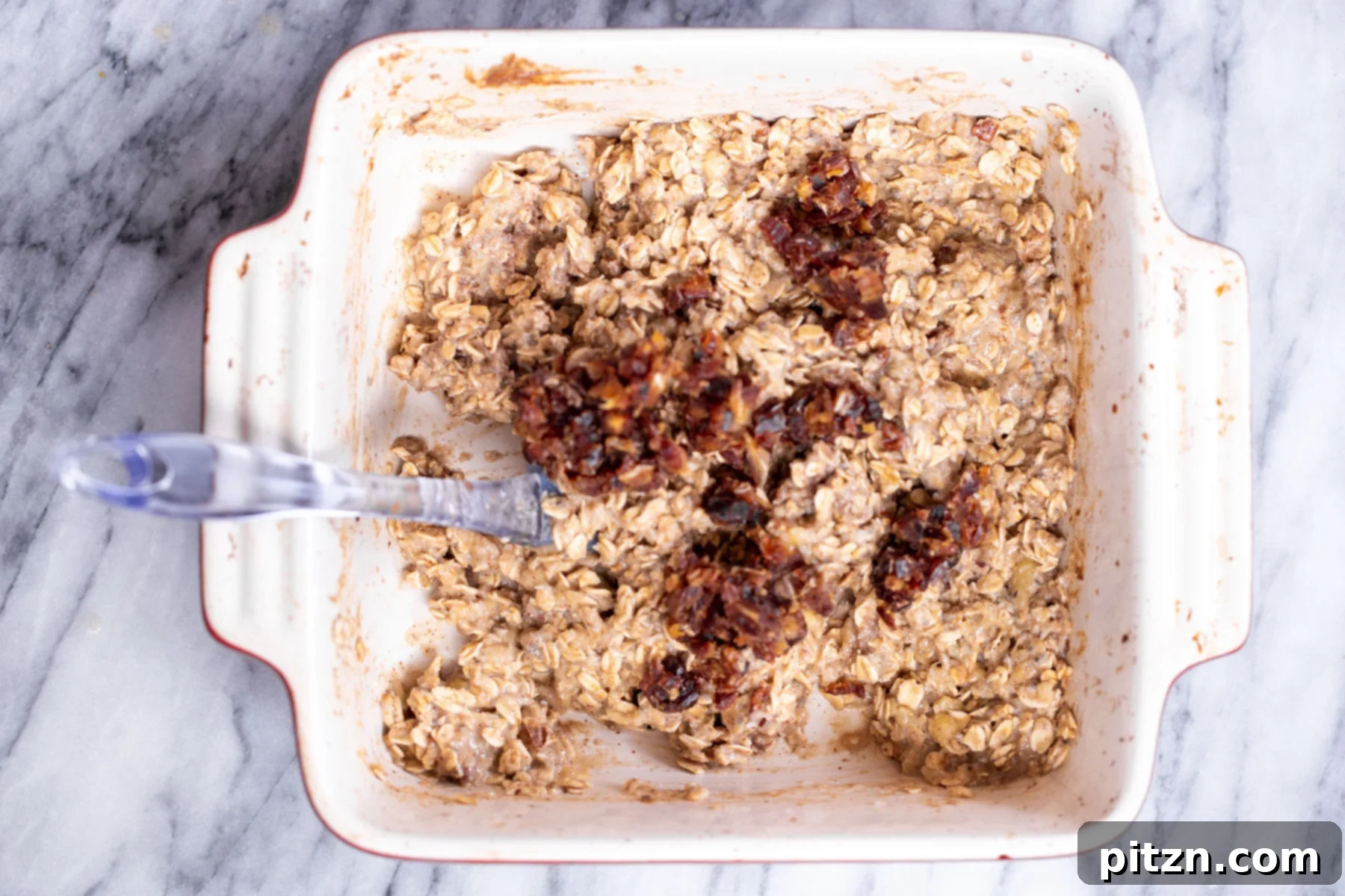 Cinnamon Streusel Vegan Banana Oat Squares 14 Sweet chopped dates being sprinkled into the banana oatmeal batter, adding natural sweetness and a chewy texture.