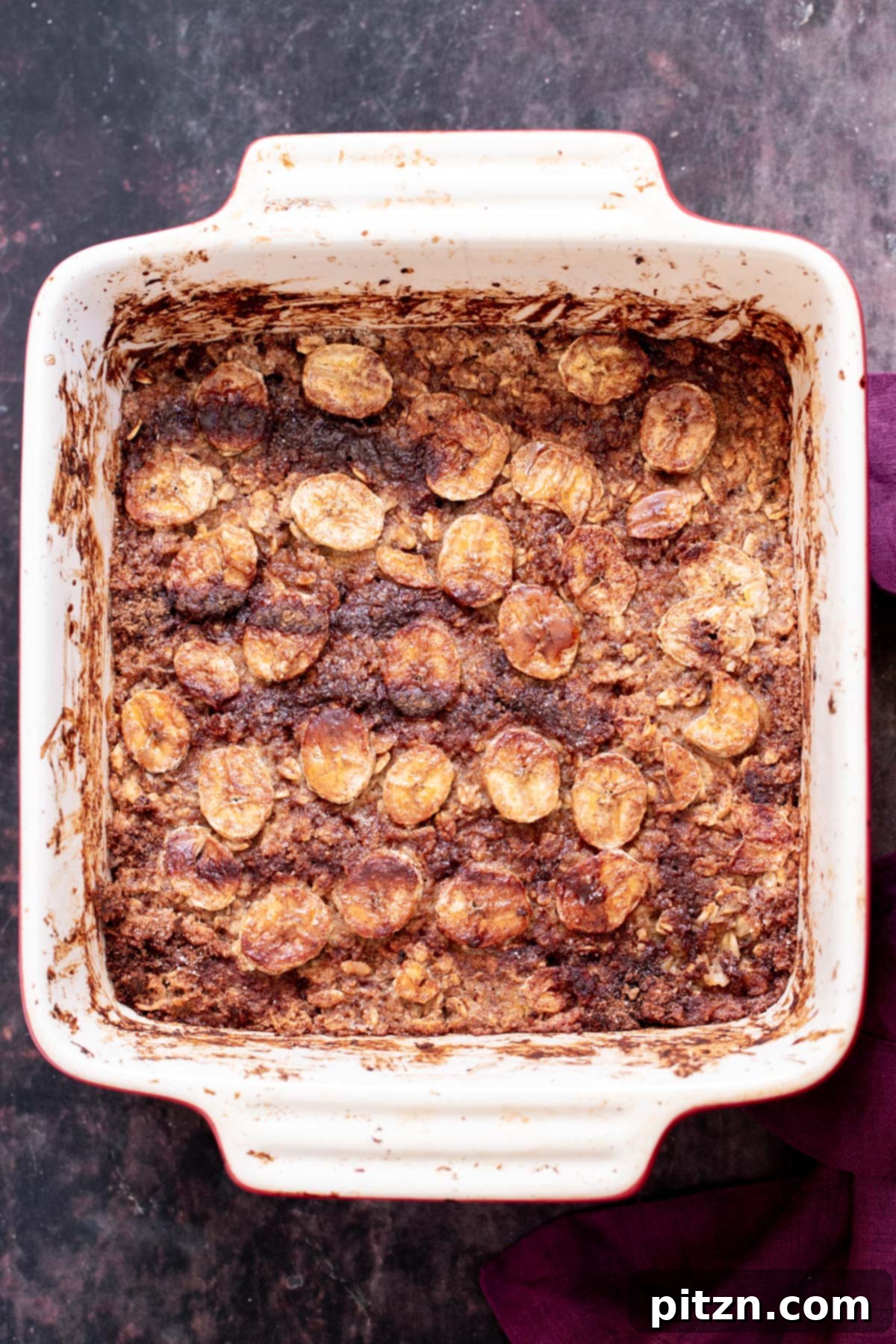 Cinnamon Streusel Vegan Banana Oat Squares 18 A golden-brown banana oatmeal casserole fresh from the oven, showing the caramelized topping and perfect doneness.