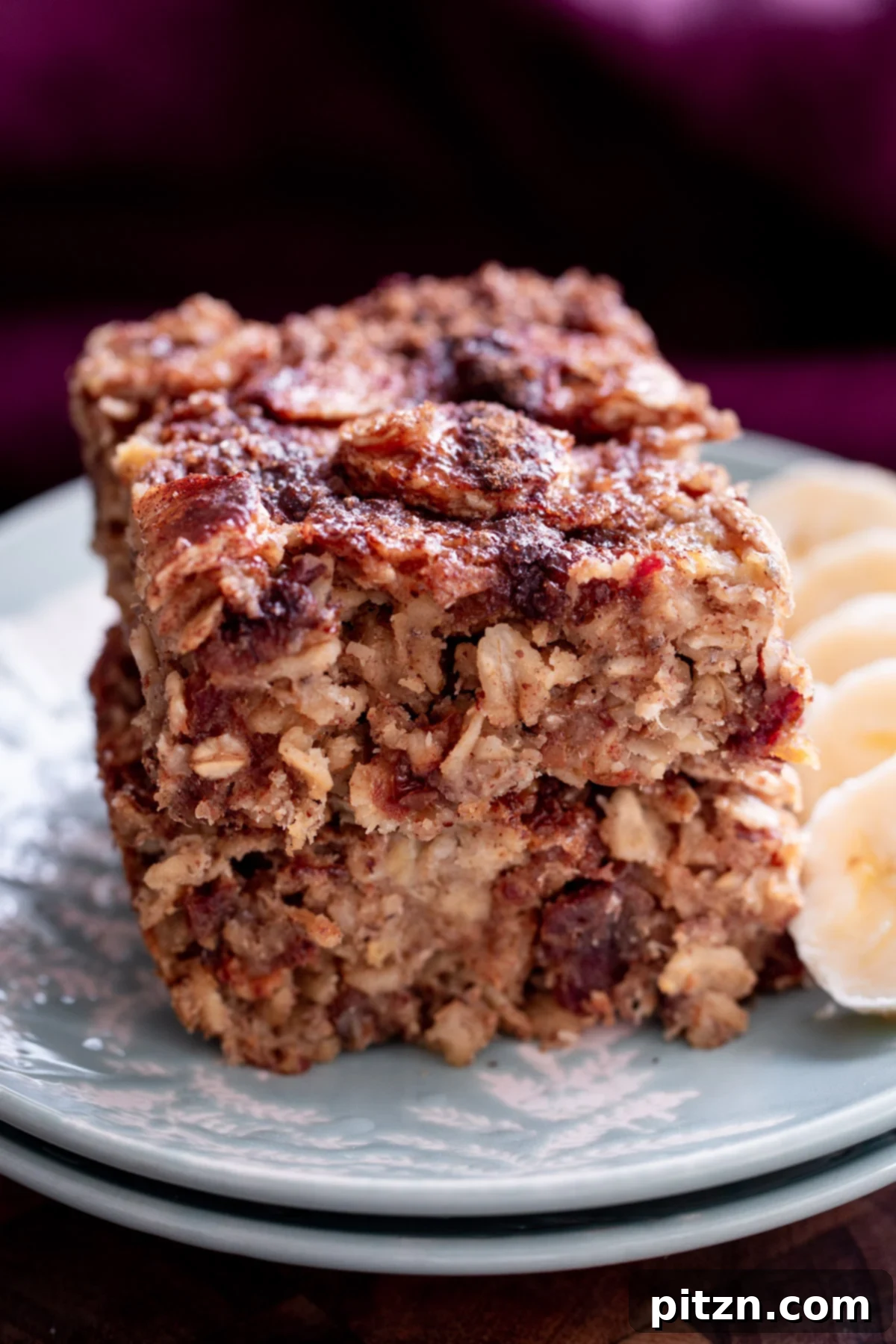 Cinnamon Streusel Vegan Banana Oat Squares 19 Stacked vegan banana oatmeal bars with a cinnamon crumb topping, ready to be enjoyed as a healthy and delicious snack.