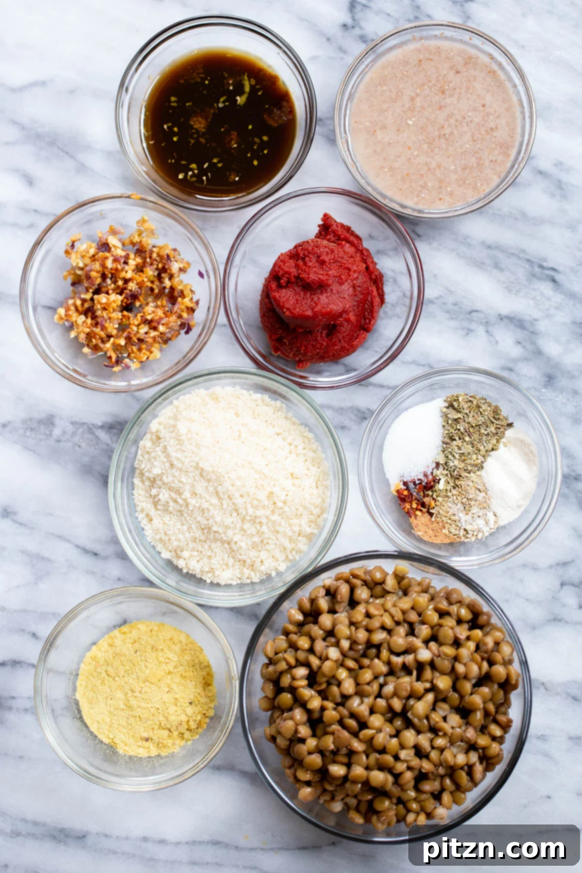 A flat lay photograph showcasing all the fresh ingredients required to prepare homemade vegan meatball subs, including lentils, spices, bread, and sauce
