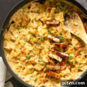 Vegan Creamy Cajun Pasta with Crisp Breaded tofu in a black skillet
