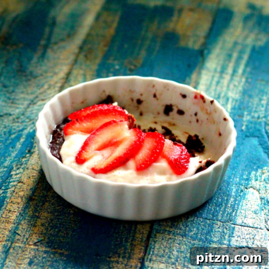 No Bake Vegan Gluten Free Chocolate Berry Fireworks Pie 5 Side view of a single-serve chocolate cream berry pie showing distinct layers of chocolate crust, cream, and berries