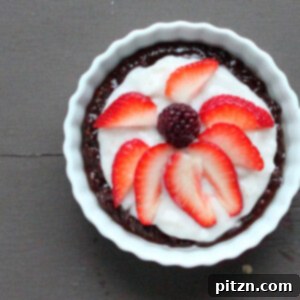 Top down shot of a chocolate cream berry pie with fresh berries arranged in an appealing pattern
