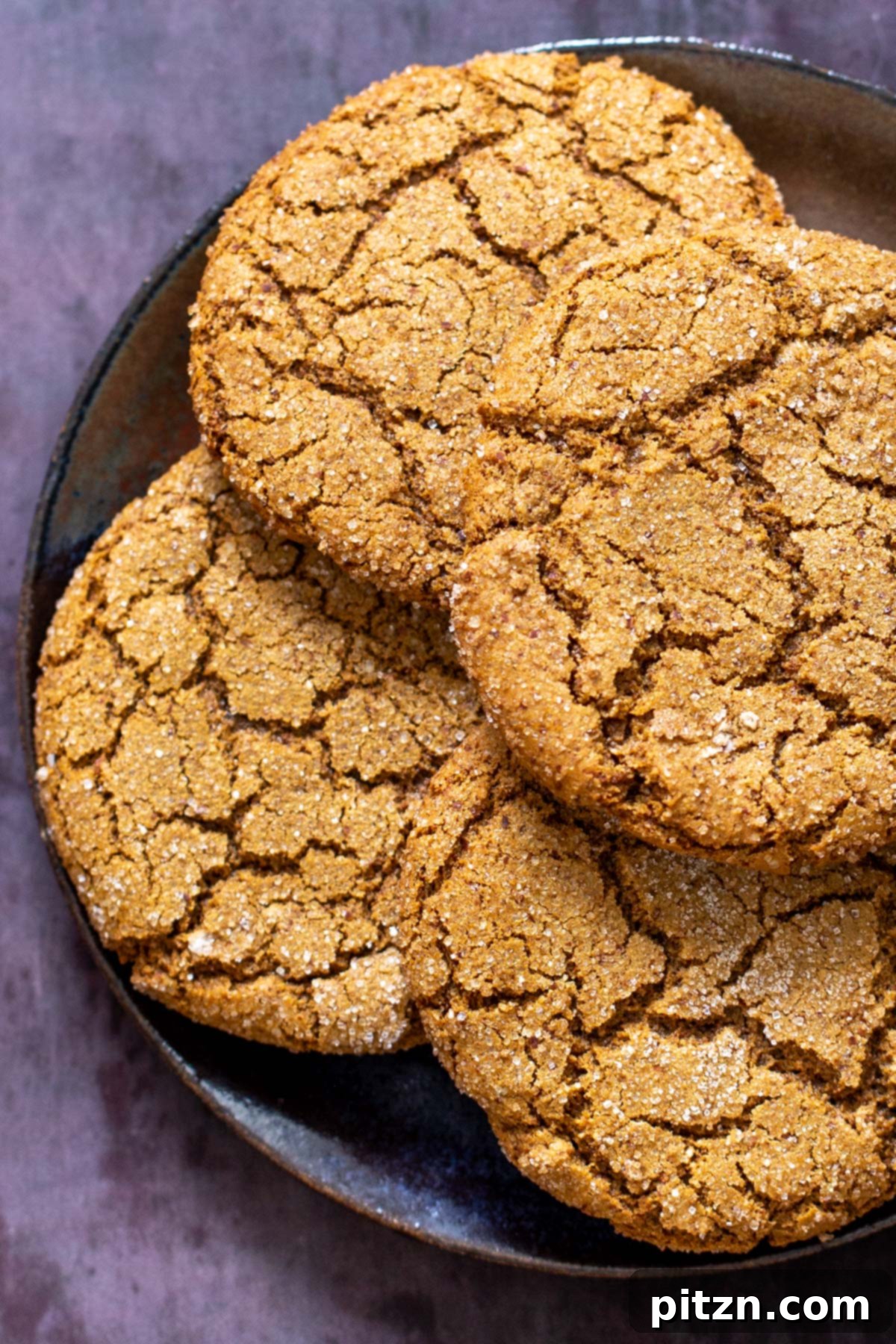 Big, crinkly vegan almond flour molasses cookies arranged on a festive platter, showcasing their soft and chewy texture and rich, spiced flavor. Gluten-free and grain-free.