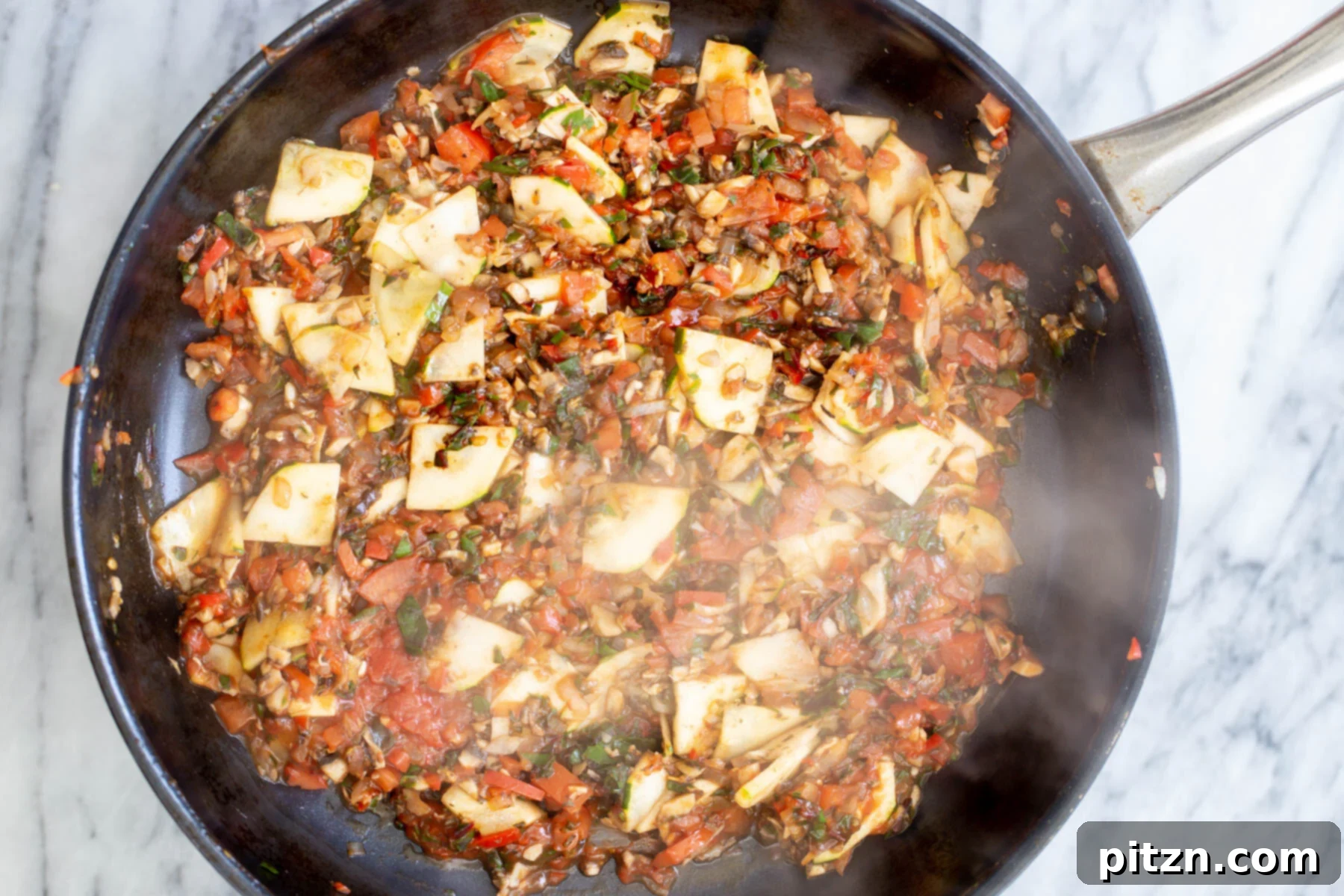 Sautéing pan filled with a colorful mix of cooked vegetables, ready for the next stage of the one-pan pasta.