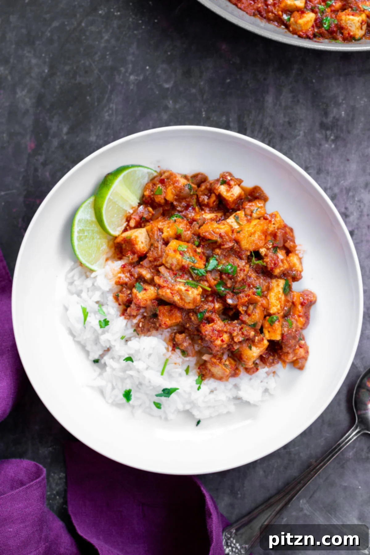 Delicious Tofu Vindaloo served on a plate with rice and fresh lime slices, ready to be enjoyed.