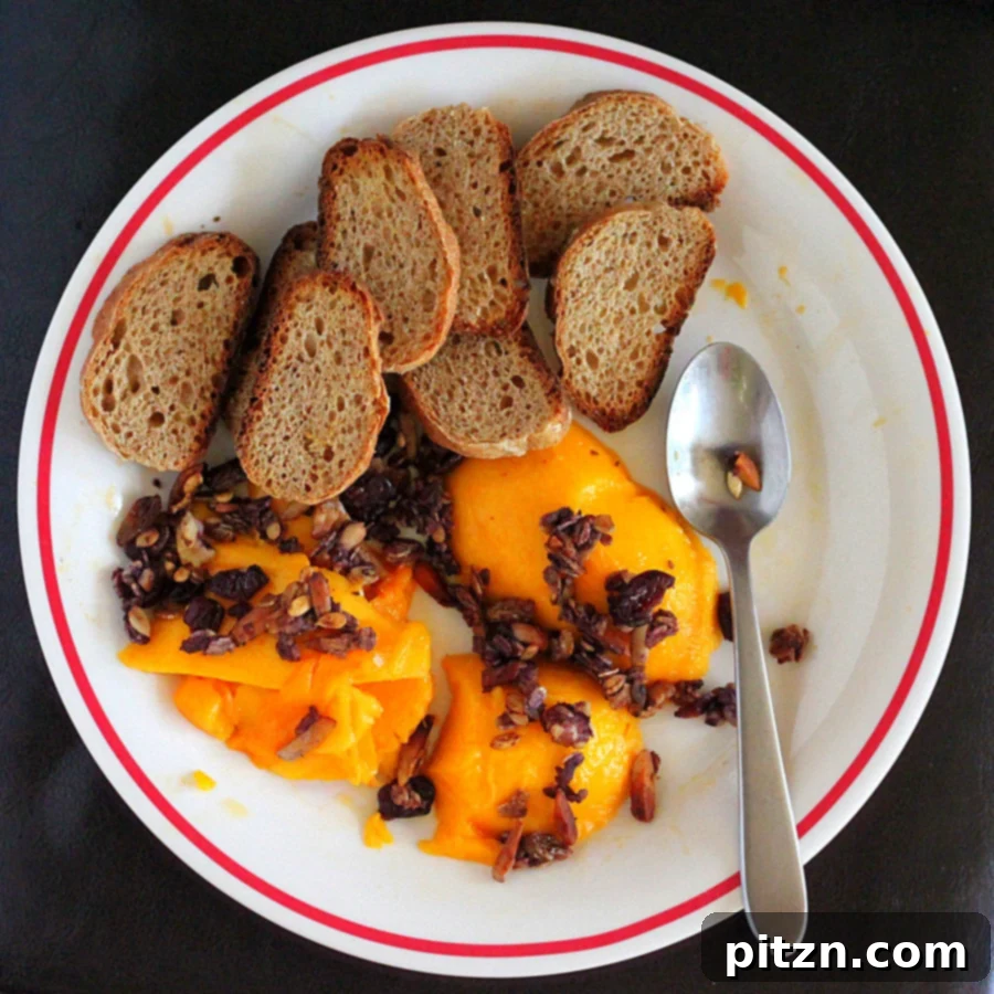 A breakfast spread featuring berry granola, fresh mangoes, wheat baguette, and masala chai.
