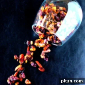 Berry Granola spilling out of a tumbler