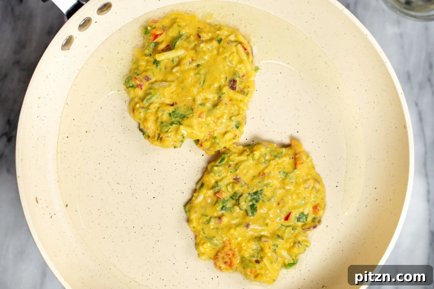 Savory Chickpea Flour Breakfast Combo 12 Golden brown vegan chickpea flour pancakes cooking in a white skillet