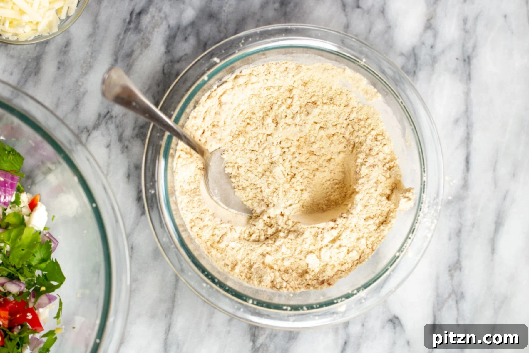 Savory Chickpea Flour Breakfast Combo 7 Dry ingredients for vegan breakfast sandwich being combined in a glass bowl