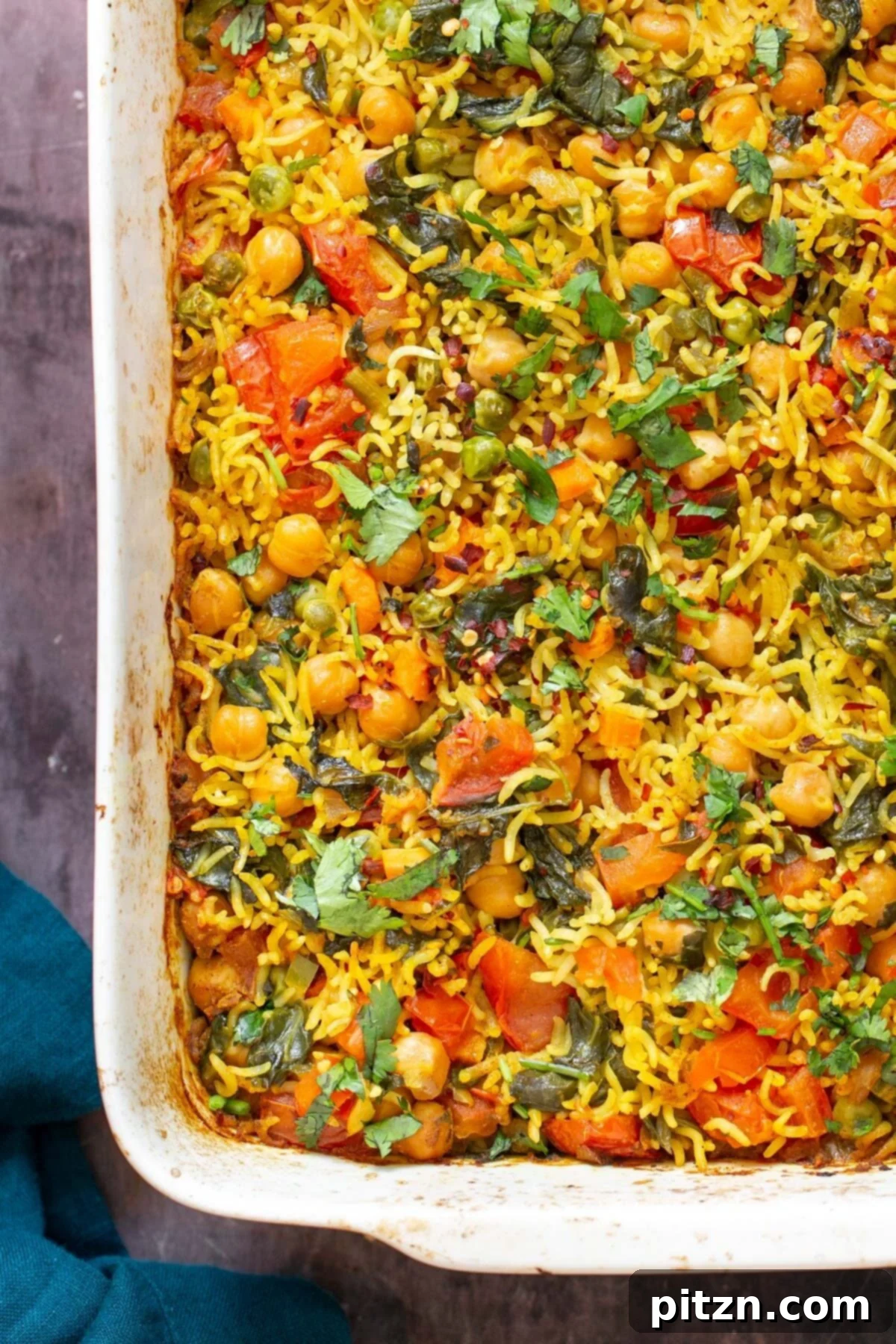 Golden Spiced Vegan Chickpea Rice Bake 12 An overhead shot of a fluffy vegan vegetable chickpea rice casserole, perfectly cooked and ready to be served.