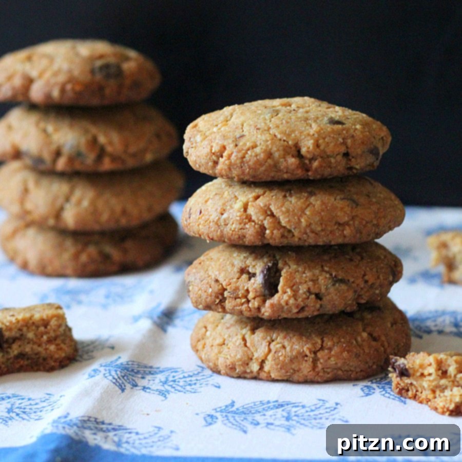 A stack of three whole grain vegan chocolate chip cookies, showcasing their thickness and rich chocolate content.