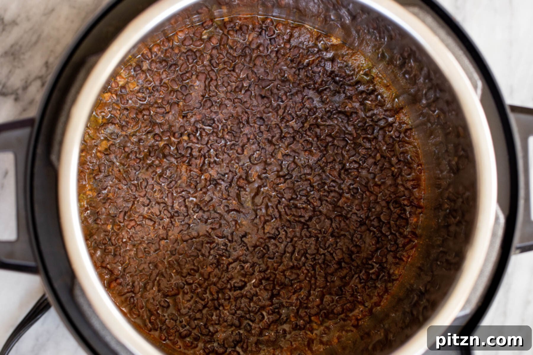 Instant Pot Dal Bukhara - Dump and Done Creamy Black Lentil Perfection 11 Perfectly cooked black gram lentils, tender and ready, resting within an Instant Pot after the pressure cooking cycle.