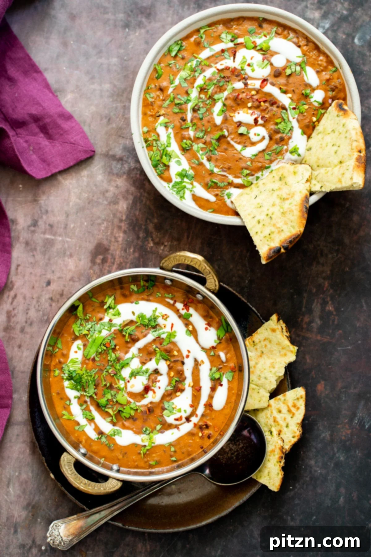 Instant Pot Dal Bukhara - Dump and Done Creamy Black Lentil Perfection 4 Two Indian serving plates showcasing a delectable Dal Bukhara, beautifully drizzled with vegan cream for a luxurious finish.