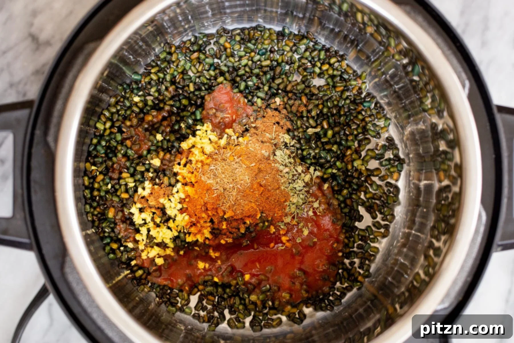 Instant Pot Dal Bukhara - Dump and Done Creamy Black Lentil Perfection 9 Whole black gram lentils, spices, and a touch of tomato paste being added to an Instant Pot, preparing for a flavorful cook.