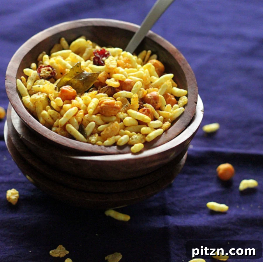 Chivda Savory PlantBased Crunch With Roasted Chickpeas And Fruits 2 A bowl of freshly made Chivda, a savory Indian snack, rich in textures and colors.