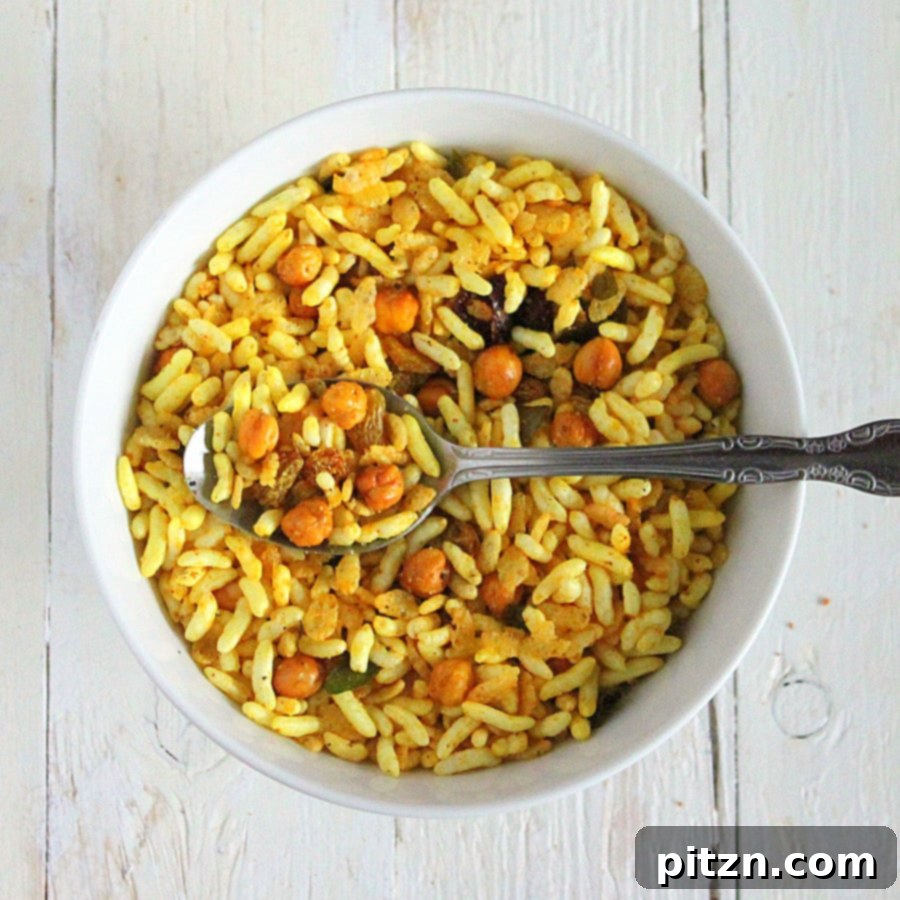 Chivda Savory PlantBased Crunch With Roasted Chickpeas And Fruits 3 Another perspective of Chivda, highlighting the mix of puffed rice, nuts, and spices.