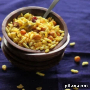 Chivda Savory PlantBased Crunch With Roasted Chickpeas And Fruits 6 Chivda served in a small bowl on a dark work surface